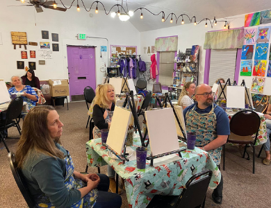 Group of people painting on easels